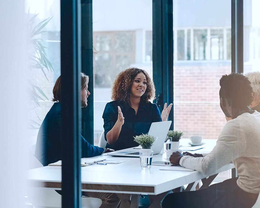 A group of professionals sitting in a modern meeting room.
